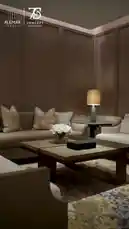 This video showcases a beautifully designed living room space, highlighting key elements such as modern furniture, sophisticated lighting, and tasteful decor. It begins with a wide shot of a cozy seating area featuring neutral-toned sofas, a stylish coffee table adorned with a vase of white flowers, and a warm ambient lamp. The camera then moves to a close-up of a shelf displaying a decorative box with a golden sculpture, emphasizing attention to detail. Another shelf features a unique glass orb and neatly stacked books, adding texture and visual interest. The focus shifts to a side table with a distinctive lamp, showcasing its elegant design and soft lighting. Throughout, the video captures the serene and inviting atmosphere of the room, demonstrating how thoughtful design choices can create a luxurious and comfortable living environment. by @alemarconcept with alemarconcept by Original Sound