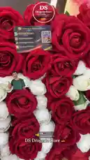 This short clip from DS Drogerie Store showcases a stunning arrangement of vibrant red and elegant white roses. The camera pans across the lush bouquet, highlighting its beauty. Overlaid graphics display the store's contact information, including WhatsApp, TikTok, and Instagram handles, along with a QR code for easy access. The German flag emoji next to 'DS Drogerie Store' emphasizes its origin. This visually appealing presentation serves as a direct marketing tool for their floral products. by @dsdrogeriestore with DS🇩🇪 by DS drogerie store🇩🇪