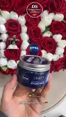 A close-up shot displays a hand holding a container of Nivea Men Styling Cream against a backdrop of a large heart-shaped arrangement of red and white roses. The 'DS Drogerie Store' logo is visible in the top right corner, along with a small image of a barber and a customer. A woman sings softly in the background. by @dsdrogeriestore with DS🇩🇪 by Ds drogerie store