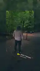 A person wearing a grey hoodie and black pants stands on a brick path in a lush green forest, facing away from the camera. The scene is accompanied by a freestyle rap track titled 'charts 1 freestyle' by pasha archive. This moment captures a contemplative walk in nature, blending urban streetwear style with serene outdoor scenery. by @marci385 with charts 1 freestyle by pasha archive