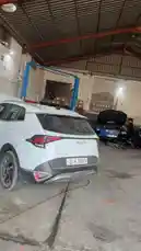 This video provides a behind-the-scenes look at Wasta Hawkar Service, a professional auto repair shop. Viewers can see a white SUV parked inside the spacious garage, with other vehicles undergoing service in the background. The environment is clean and well-equipped, showcasing the daily operations of a modern car servicing facility. by @hawkar_service with Original Sound by hawkar_service