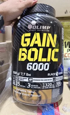 A close-up look at the Olimp Sport Nutrition Gain Bolic 6000 Black mass gainer tub, highlighting its key features like 35 servings, 1320mg pure creatine, and 'incredible taste' chocolate flavor. This product-focused shot is ideal for anyone researching top-tier supplements for muscle gain. by @lanutritioniraq with original sound