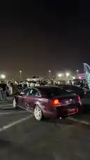 Witness the vibrant energy of a nighttime car meet, spotlighting a customized maroon Chevrolet Impala. This scene captures the essence of automotive culture, where enthusiasts gather under the lights to admire unique builds and share their passion. by @mo_kbs8 with A. Act fool by Contains: Act A Fool - Ludacris