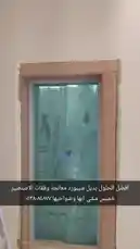 This video provides a detailed walkthrough of installing a frameless glass shower door within a wooden frame. A worker is seen carefully positioning the large glass panel into the prepared opening, demonstrating the precision required for a professional finish. The surrounding area shows signs of ongoing renovation, including protective plastic sheeting, which highlights the importance of dust control during such projects. The audio narration explains that the 'frame' is being treated with MDF before the final glass installation, emphasizing a multi-step process for durability and aesthetics. This clip serves as a practical tutorial for anyone undertaking bathroom remodeling or glass door installations. by @zoodasas with Original Sound by zoodasas