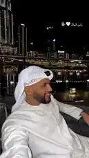 Experience a stunning night view of Dubai's iconic skyline, including the Burj Khalifa, as a man dressed in traditional white thobe and ghutra enjoys the serene waterfront ambiance. This elegant scene captures the fusion of modern luxury and cultural heritage, perfect for those interested in lifestyle, fashion, and travel inspiration. by @th4eb with انا الارباح 🎵 by ♥️