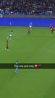 An intense moment from a Serie A football match, showcasing a dramatic tackle between players from opposing teams. The player in the red and black striped jersey attempts to control the ball but is brought down by a defender in light blue. The crowd in the stadium watches closely as the play unfolds under bright lights. by @seriea with Original Sound by seriea