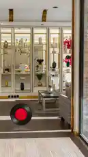 Step into the world of Armada Residence, where modern elegance meets functional luxury. This captivating space features sleek design elements, including a stylish glass-enclosed display cabinet filled with artful ceramics and vases, a minimalist coffee table, and warm wooden flooring that creates an inviting atmosphere. A unique red vinyl record graphic adds a playful touch to the sophisticated setting. Explore how Armada Residence blends contemporary style with comfort for an exceptional living experience. by @armadar25 with armadar25 by Original Sound