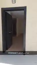This walkthrough video shows a newly installed SPC waterproof flooring throughout a house. The camera pans across various rooms, including hallways and living areas, highlighting the light wood-look planks. A blue crate with tools sits in one corner, suggesting the work is recently completed. The speaker confirms the full installation is done and only the final finishing touches remain. by @zoodasas with Original Sound by zoodasas