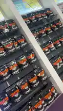 This video provides a clear, close-up view of LA Nutrition's Creatine Monohydrate product neatly arranged on retail shelves. The camera slowly pans across multiple rows of black packaging with bold orange branding, highlighting the product's availability and presentation in a modern supplement store. A promotional sign for 'Apple Pie' flavor is visible above, suggesting a broader product range. The clean, organized layout emphasizes accessibility and brand consistency, ideal for customers seeking trusted creatine supplements. by @lanutritioniraq with original sound