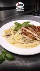 Watch as a perfectly grilled chicken breast is sliced and served over creamy penne pasta with mushrooms and fresh basil. This elegant dish, presented by Segafredo Hebron, showcases simple ingredients elevated with rich flavors and professional technique. by @segafredohebron with original sound