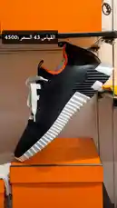 A close-up showcase of a sleek black and white Hermès sneaker, size 43, displayed on a signature orange box. The price tag of 4500 is clearly visible, highlighting the luxury appeal. This stylish footwear presentation is perfect for fashion enthusiasts and collectors. by @lussowatches with original sound