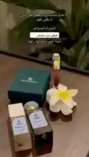 A stylish unboxing of the SOINS Heaven Eau de Parfum, presented alongside a beautiful necklace gift set. This elegant collection features the SOINS fragrance bottle, its packaging, and a matching FAYENDRA jewelry box, all arranged with a white frangipani flower for a touch of luxury. The Arabic text overlay invites viewers to share their thoughts on the scent. by @soins_sa with Original Sound by soins_sa