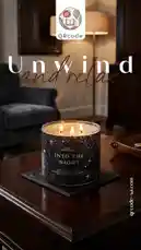 A beautifully lit candle named 'Into the Night' from Bath & Body Works is showcased in a cozy living room setting. The three-wick candle flickers gently on a dark wooden table, creating a warm and inviting atmosphere. Text overlays reading 'Unwind and relax' enhance the calming theme. The QRcode SA logo is visible, suggesting a promotional or lifestyle-focused content piece. by @qacodee with original sound