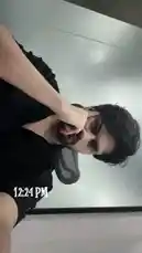 In this brief, candid clip, content creator D SUN 🇦🇪🇮🇳 captures a lighthearted moment in a personal setting. He makes a playful face, sticking his tongue out while holding his hand near his head, seemingly recording a casual snapshot for his audience. The timestamp '12:24 PM' is visible on screen, anchoring the moment in time. The relaxed posture and informal attire suggest an unscripted, authentic interaction aimed at connecting with followers. by @dsunmusic with original sound
