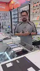 A salesperson at محل السوبر الذهبي للهواتف demonstrates various iPhone models, including the iPhone 14, iPhone 14 Pro, and iPhone 15, while discussing their prices, storage capacity, and battery health. He also showcases an Honor X5c Plus phone. This is a direct look at the available inventory and pricing for customers. by @super_golden7 with Original Sound by super_golden7
