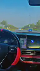 Experience a first-person perspective from behind the wheel during a scenic drive. This clip showcases a modern car interior with a sleek dashboard, digital displays, and a smartphone mounted for navigation. The road ahead is lined with palm trees under a clear sky, suggesting a warm, pleasant climate. As the vehicle moves smoothly along the highway, the focus remains on the journey and the technology guiding it. This immersive scene captures the essence of contemporary driving, blending comfort, connectivity, and the open road. by @djsefo with original sound
