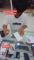 In this unboxing video, a staff member from 'محل السوبر الذهبي للهواتف' (The Golden Super Store) meticulously opens a new iPhone 13 Pro Max 512GB box. He carefully removes the phone, showcasing its sleek design, and presents it alongside complimentary accessories like a power bank and a stylish case. This detailed walkthrough offers a clear view of the device's packaging and contents, perfect for anyone considering a purchase. by @super_golden7 with Original Sound by super_golden7
