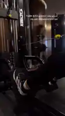 This close-up shot shows a person performing leg press exercises on a black XELAXIS machine in a modern gym. The individual is wearing black leggings and black-and-white Adidas sneakers. Text overlays in Arabic and English read 'You are stronger every day.' This video serves as a visual guide for proper form during leg presses, a key lower-body strength training exercise. by @activecircle with original sound