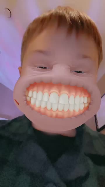 Preview for a Spotlight video that uses the Grinning Face Lens